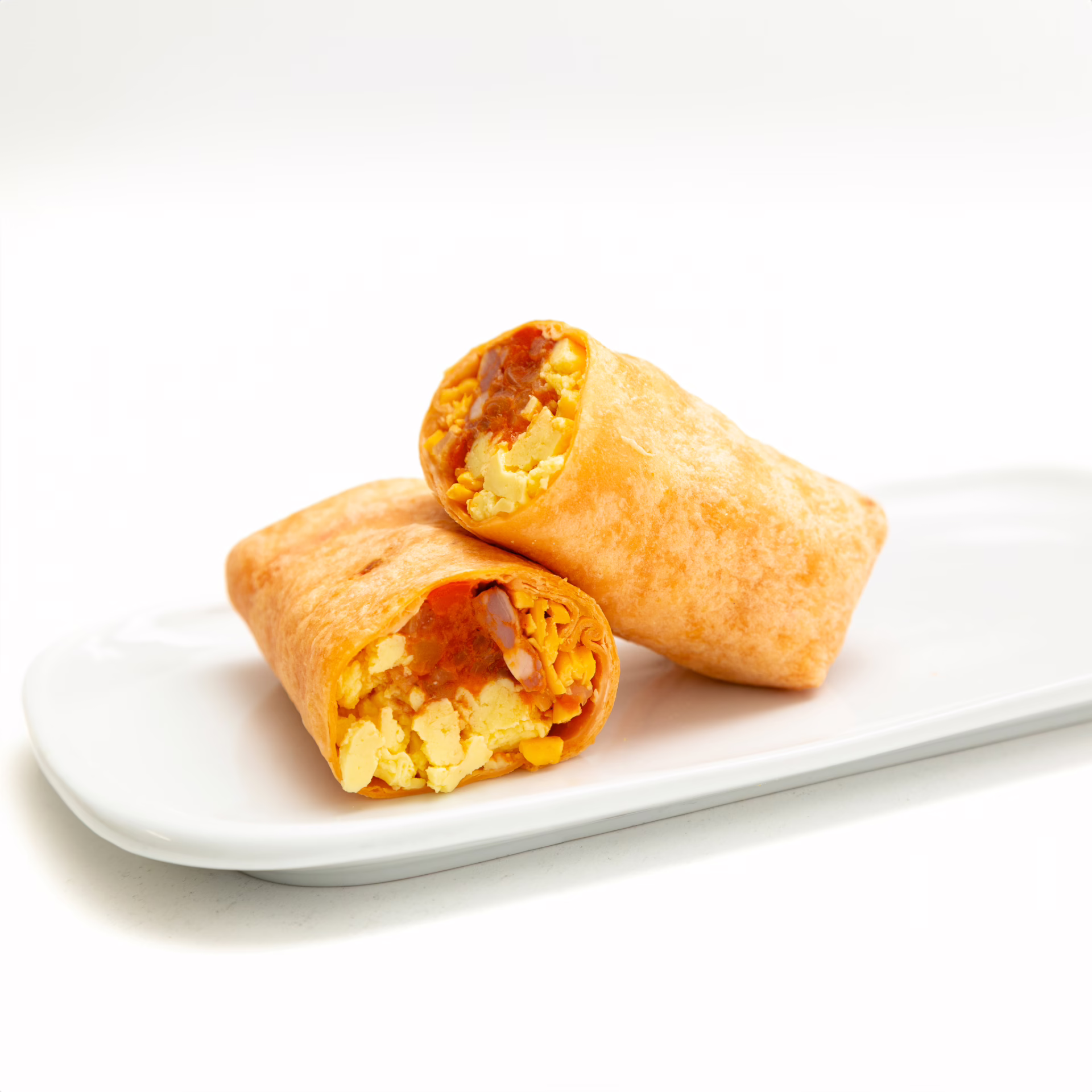 Cheddar flour tortilla wrap with Chorizo, Cheddar Cheese, Scrambled eggs inside presented on a white plate