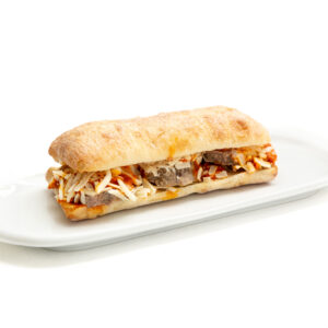 White Sub Ciabatta bread with Kobe Meatballs, Smoked Gouda Cheese, Mayo presented on a white plate