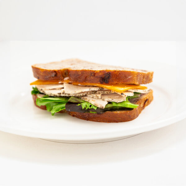 Cranberry loaf, turkey breast, cranberry mayonnaise, and spring mix lettuce and smoked gouda cheese.