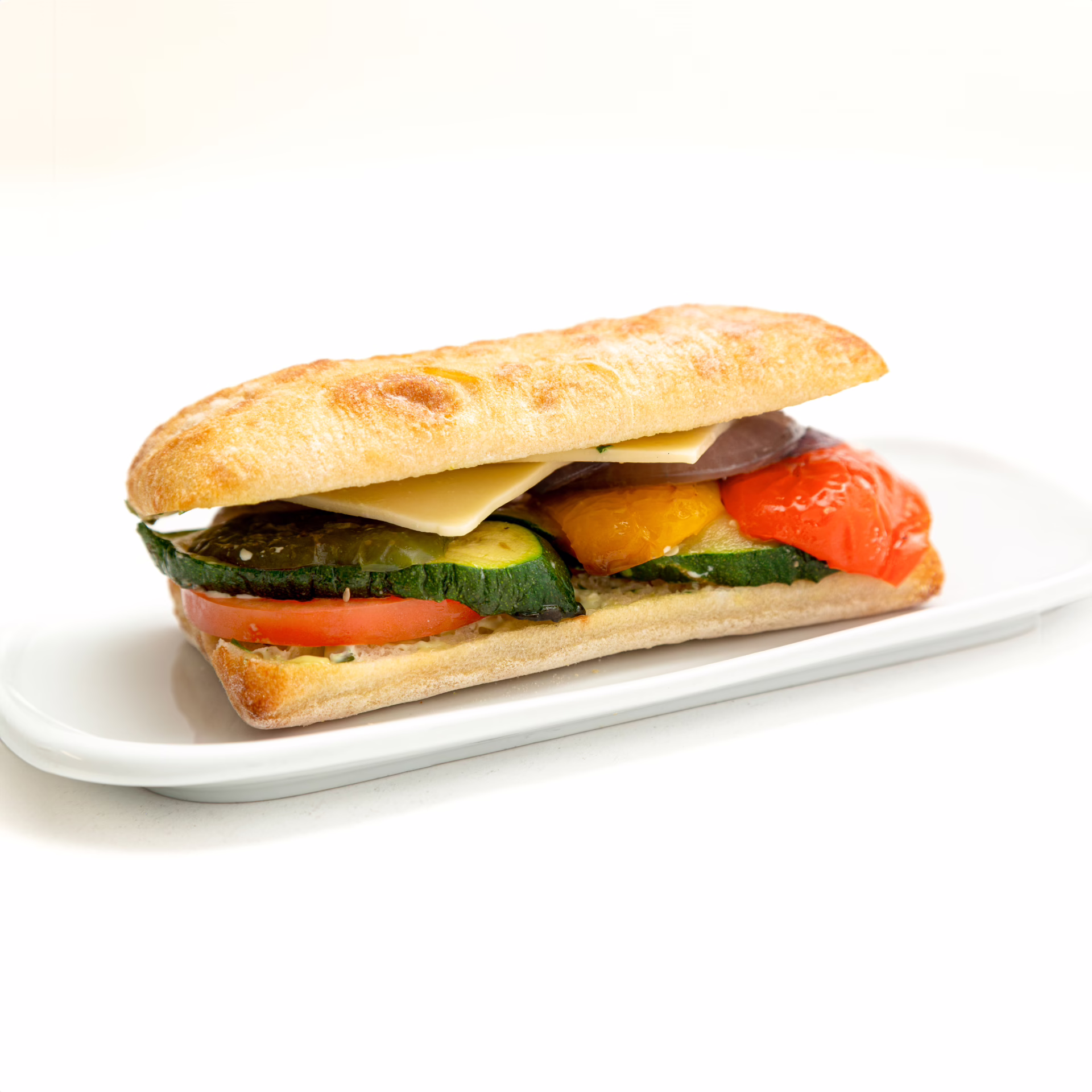 ROASTED VEGETABLE with Ciabatta bread, Roasted Peppers, Zucchini, and onions, tomato, Swiss Cheese + Pesto mayonnaise.