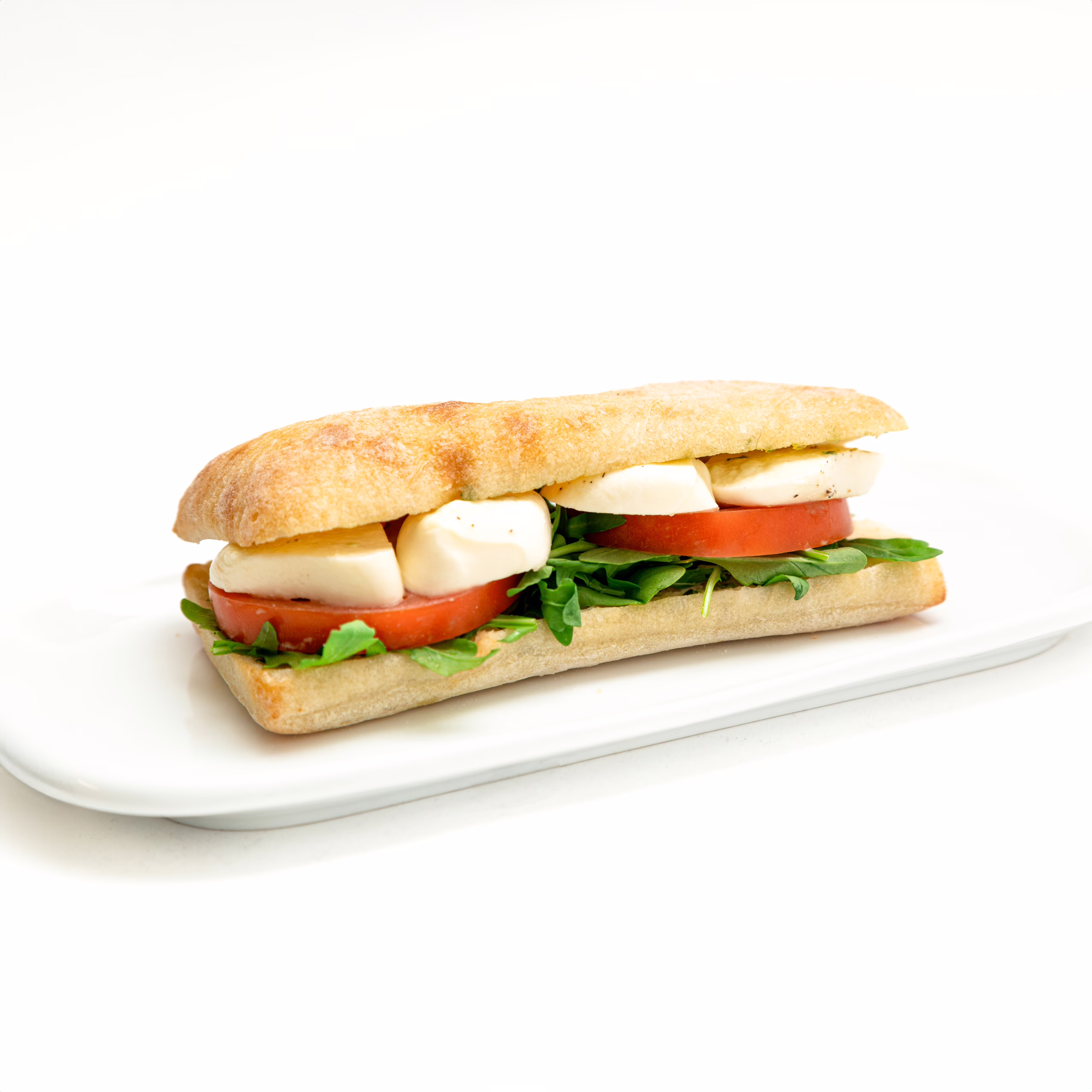 Meinhardt-TOMATO-BOCCONCINI-ARUGULA-Sub-Sandwich Ciabatta pan bread, pesto mayonaisse, arugula, bocconcini, tomoato, basil, salt and pepper.