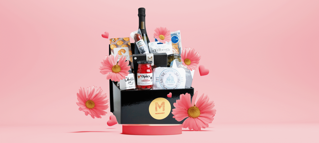 3d render background for celebrate International Women's Day with elegant podium design featuring pastel tones and floral accents. Meinhardt Season Sparkles Prosecco gift basket on the podium.